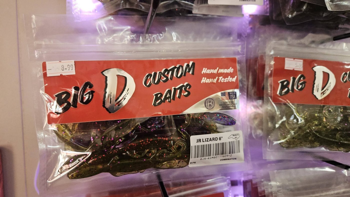 A package of Big D Custom Baits 6-inch Jr Lizards hanging on the wall at Falls Lake Outpost